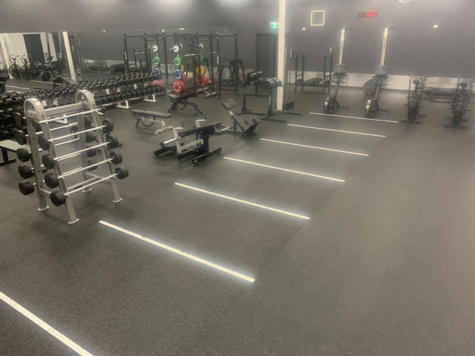 Gym floor with racks and free weights